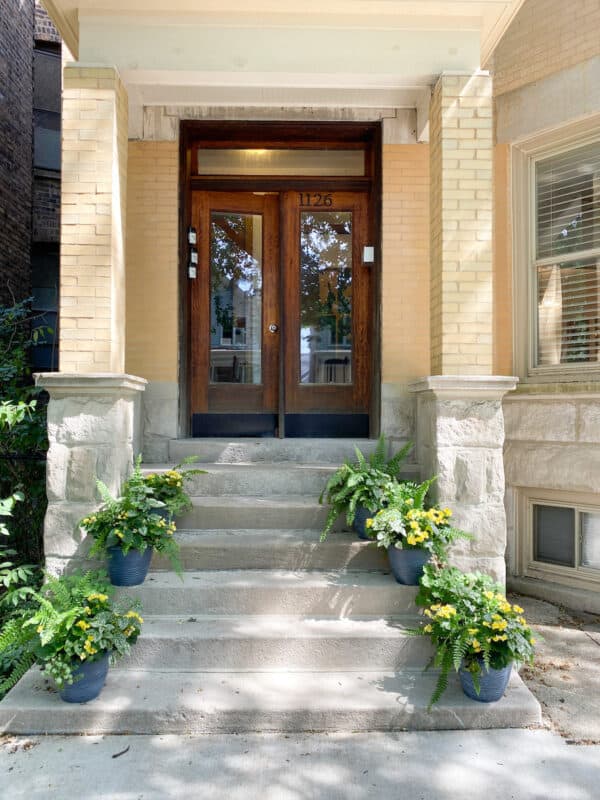 the front porch of a 3-flat walk-up in the city of Chicago