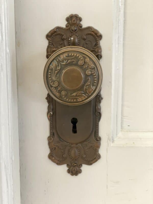 A vintage door handle and lock plate