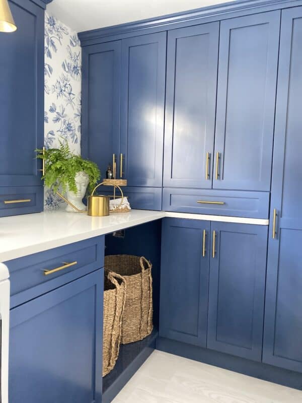 beautiful corner of new laundry room with blue custom cabinets