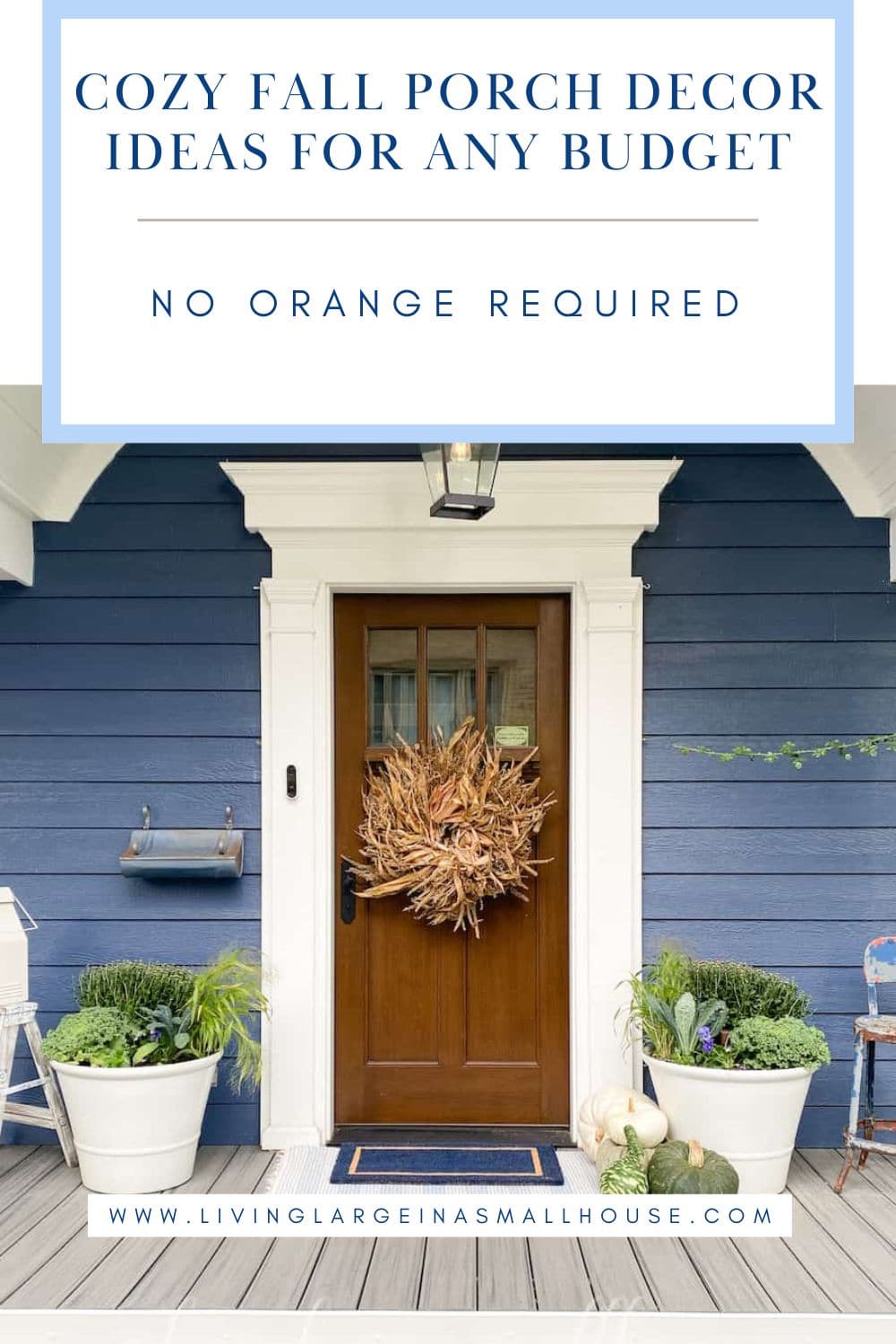 Blue house porch with a brown door, fall wreath, potted plants, pumpkin—classic fall porch decor ideas without orange.