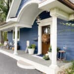popular view of my blue sided home and our front porch dressed for fall with simple fall porch decor ideas