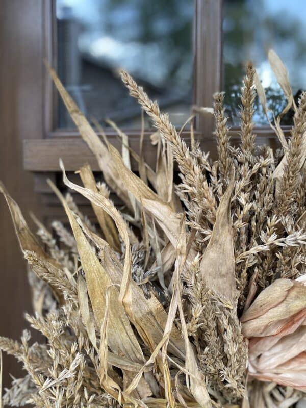 corner of my corn husk wreath hanging on my front door. A simple front porch decor