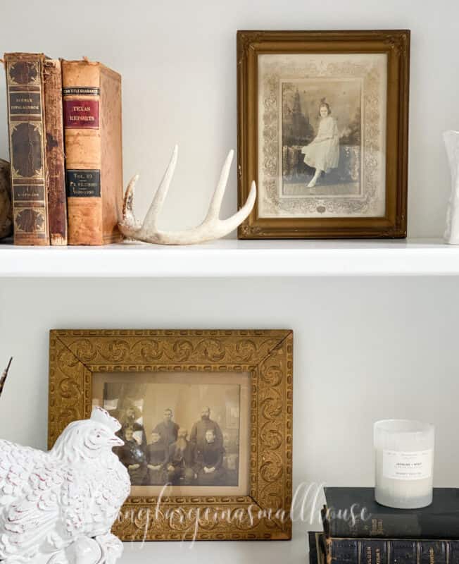 vintage frames with old pictures of people give a neutral halloween decor look