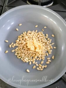 pine nuts and garlic sauteing for pesto