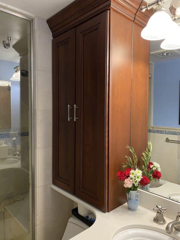 a cabinet above the toilet with lots of space for small bathroom storage