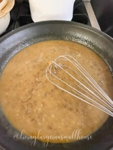 swedish meatball sauce in fry pan before pouring it over pan fried meatballs