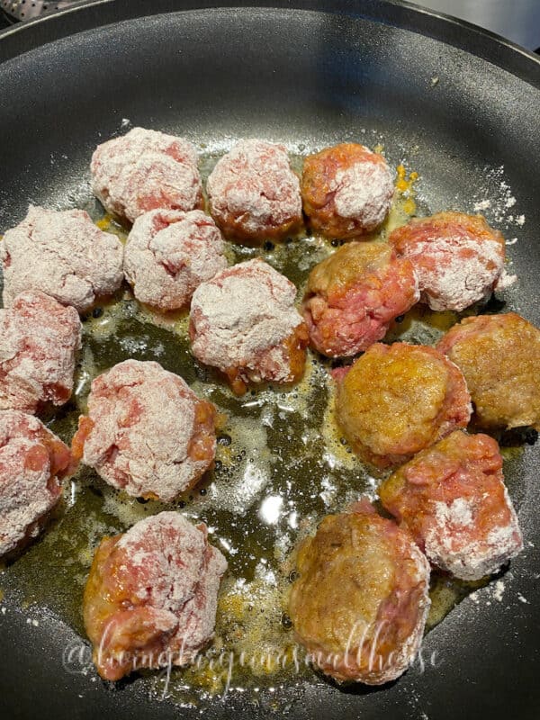 frying up the Swedish meatballs in a fry pan with oil and butter