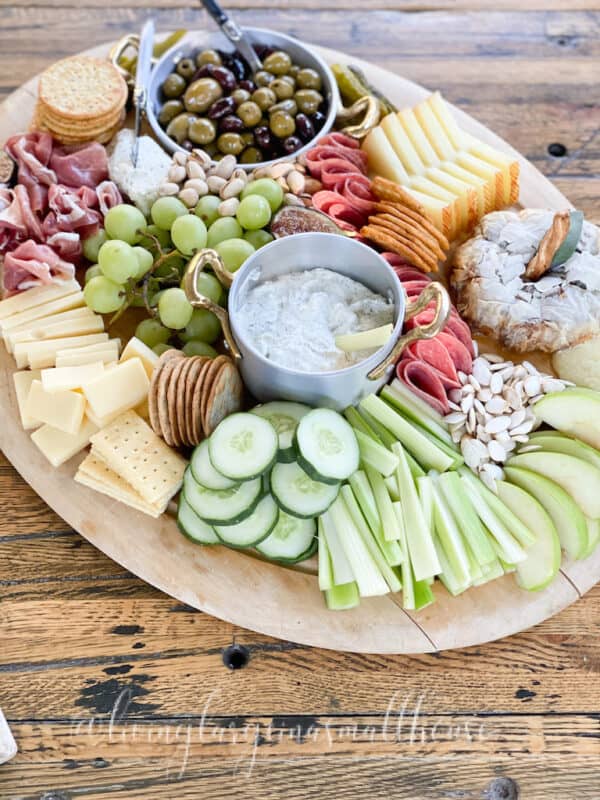 wooden board filled with cheese, deli meats, crackers and more for a fall charcuterie board