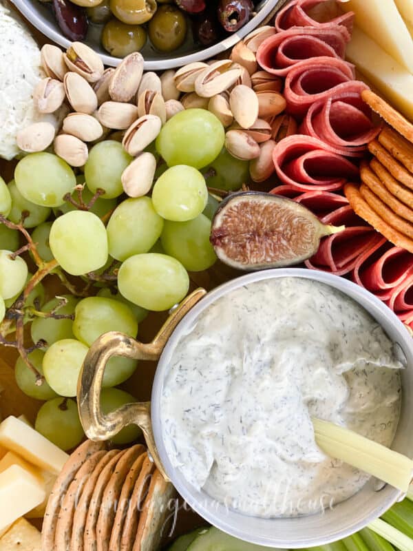 a overhead photo of a fall charcuterie board with a fig to add interest