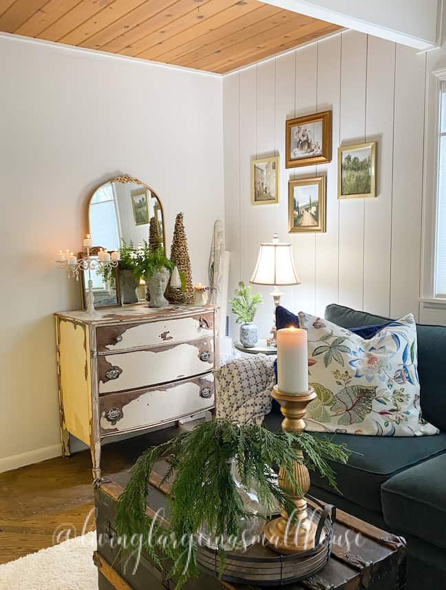 the corner where the desk used to be in the one room challenge. It now is a dresser with a large mirror and French art work on the wall