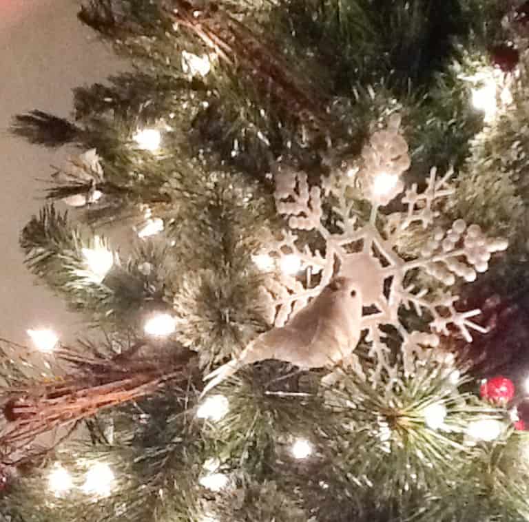 close up of white dollar tree snowflakes on the christmas tree a way to celebrate christmas on a budget