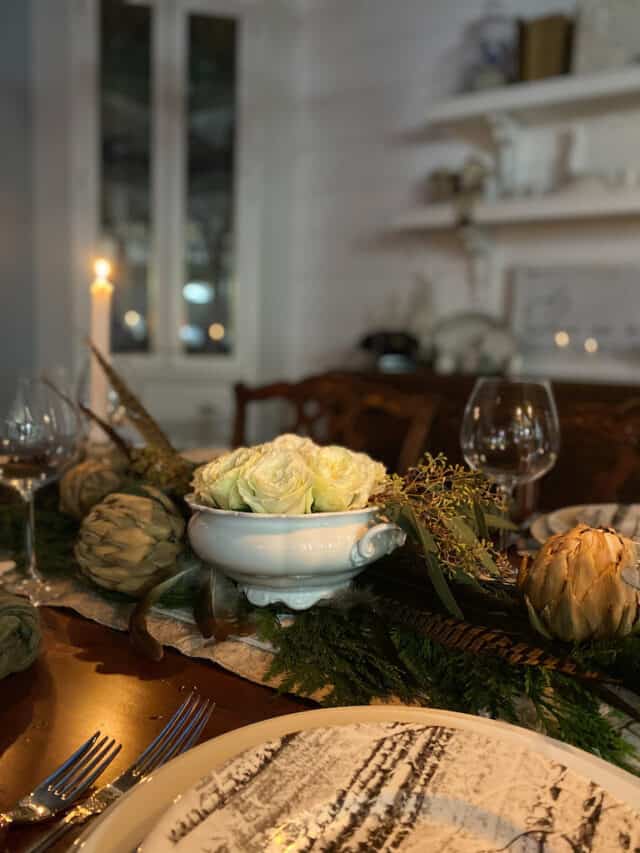 the woodland christmas tablescape at night with the candles lit