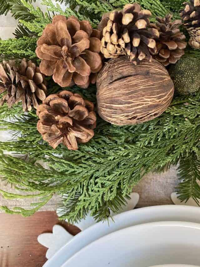 a photo of the greenery and natural elements of the woodland christmas tablescape