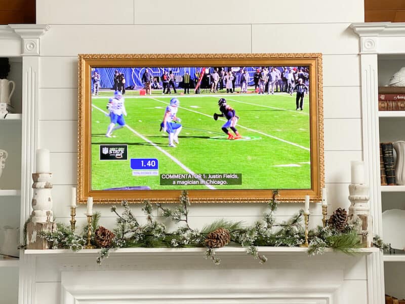 football game on frame TV over holiday mantel for a football party. An idea for holiday entertaining on a budget