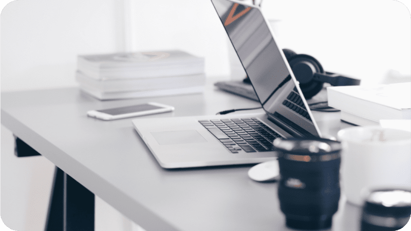 a photo of a bloggers desk with a laptop and photography equipment