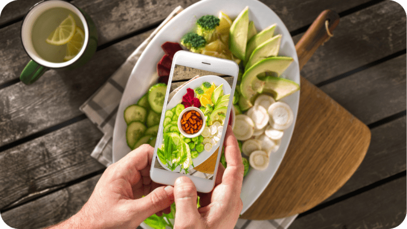 photograph of a food blogger photographing food for her blog about how does a blogger make money?