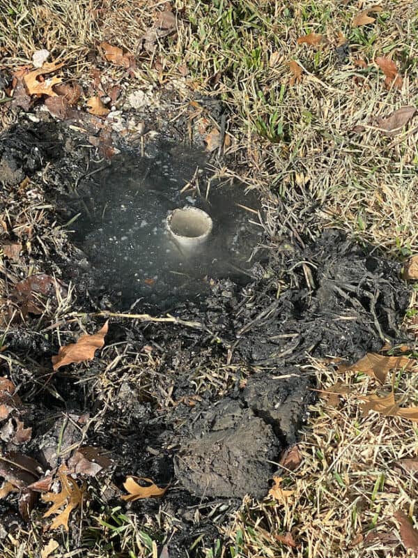 picture of an uncapped drain pipe coming from a flipped house to the outside