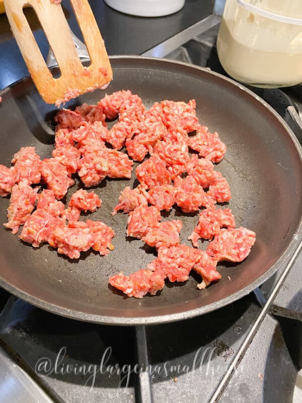 cooking sausage for a topping on the sourdough starter discard pizza crust