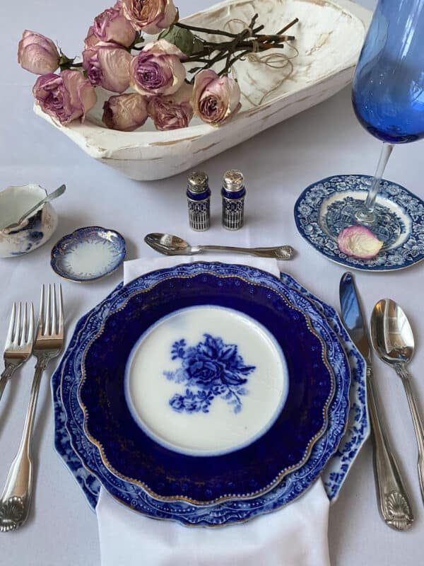 Valentine's Day tablescape with flow blue dishes and rose petals