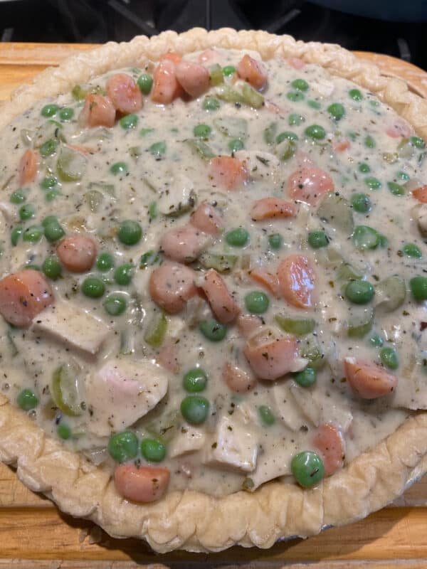 the pie crust with pot pie filling ready to be baked.