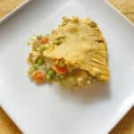 a slice of chicken pot pie with a beautiful golden crust.