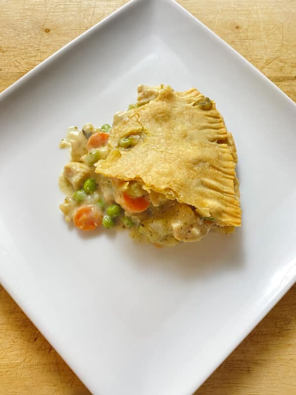 a slice of chicken pot pie with a beautiful golden crust.