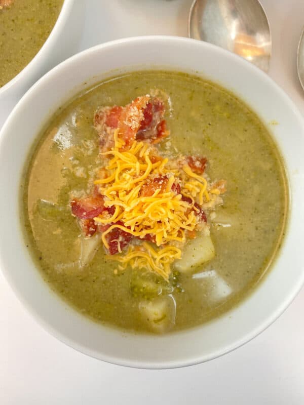 potato, broccoli and leek soup with a bread, bacon and cheese topping