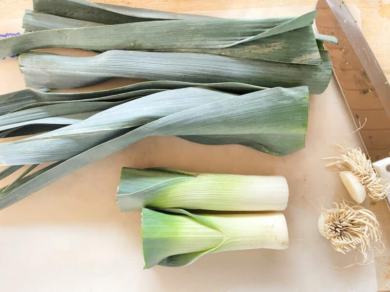 the ends of the leek, the greens of the leek and the white part of the leek which we are using for the soup