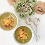 two bowls of potato, broccoli, and leek soup