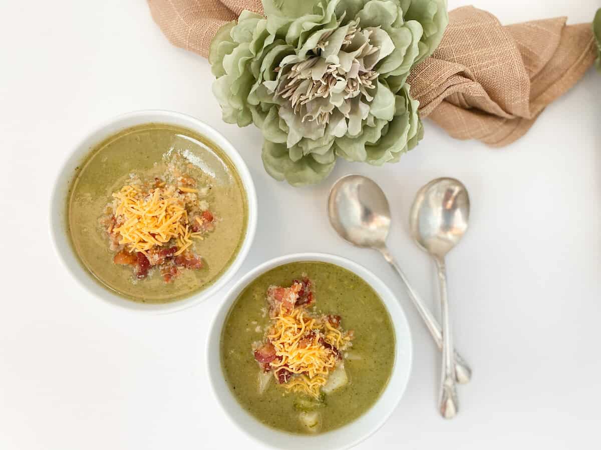 two bowls of potato, broccoli, and leek soup