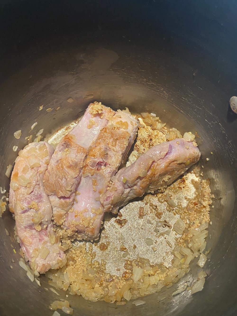 browned pork bones with onions for flavor of the traditional Italian pasta sauce