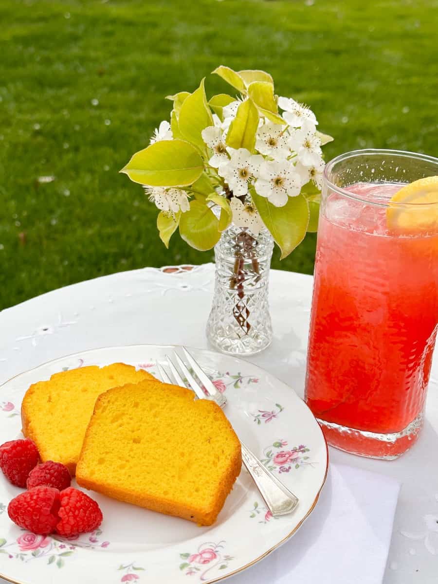 a table with raspberry cordial lemonade with lemon cake