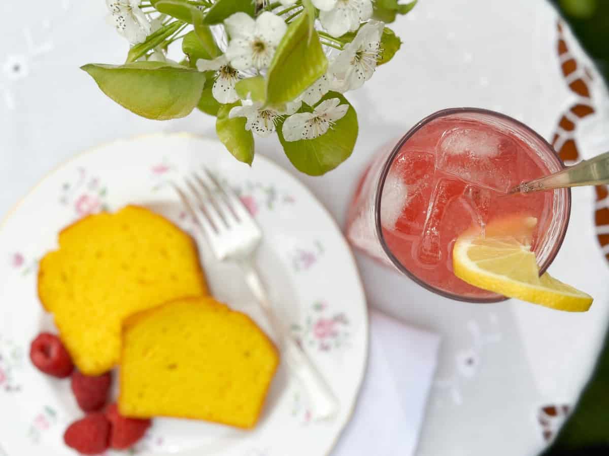 a table with raspberry cordial lemonade with lemon cake 