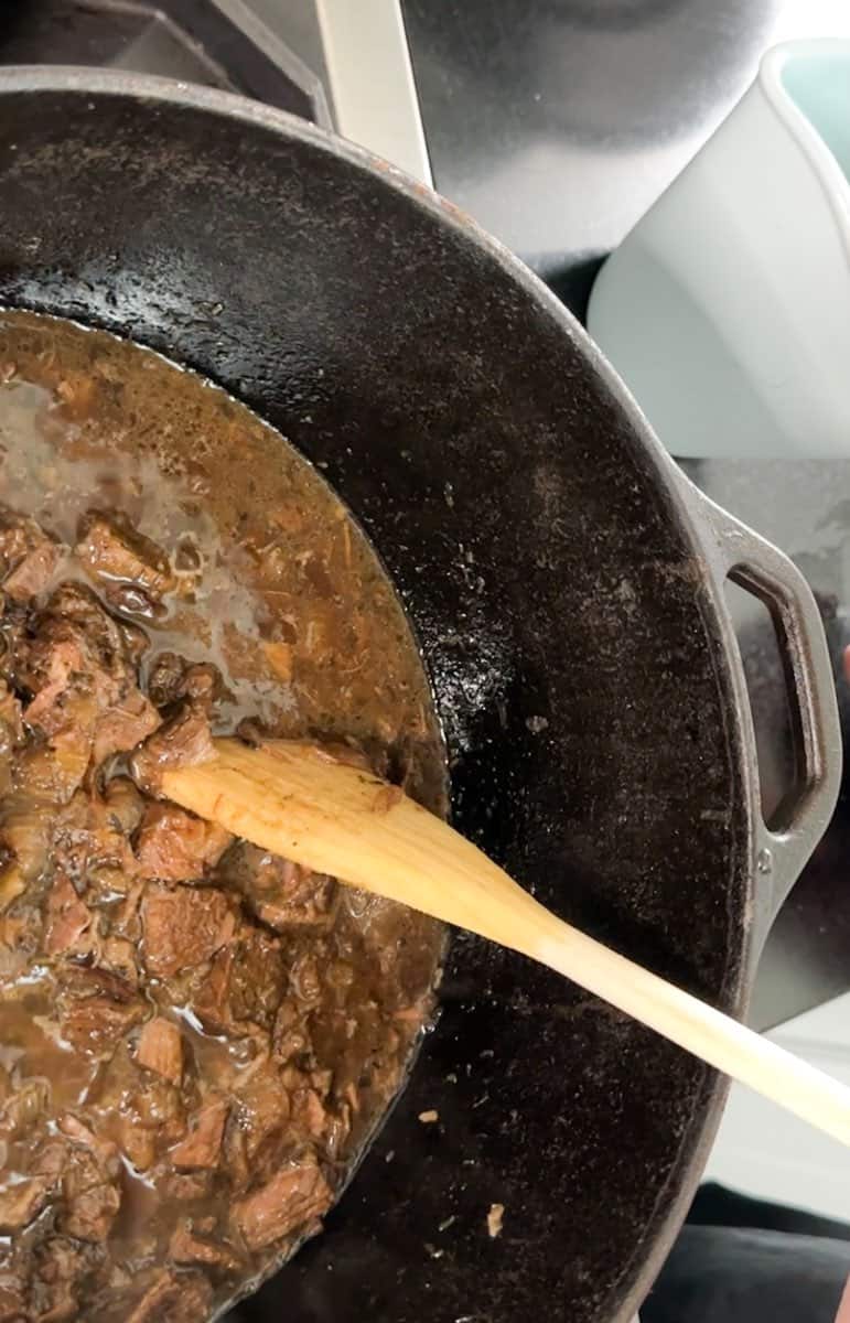 Dutch oven with beef tips and onion gravy cooked and ready to serve.