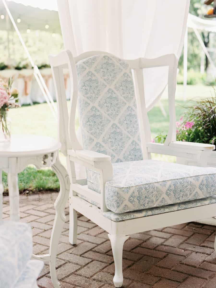a vintage chair in the outdoor living room at our home which was the site for our daughters intimate vintage backyard wedding