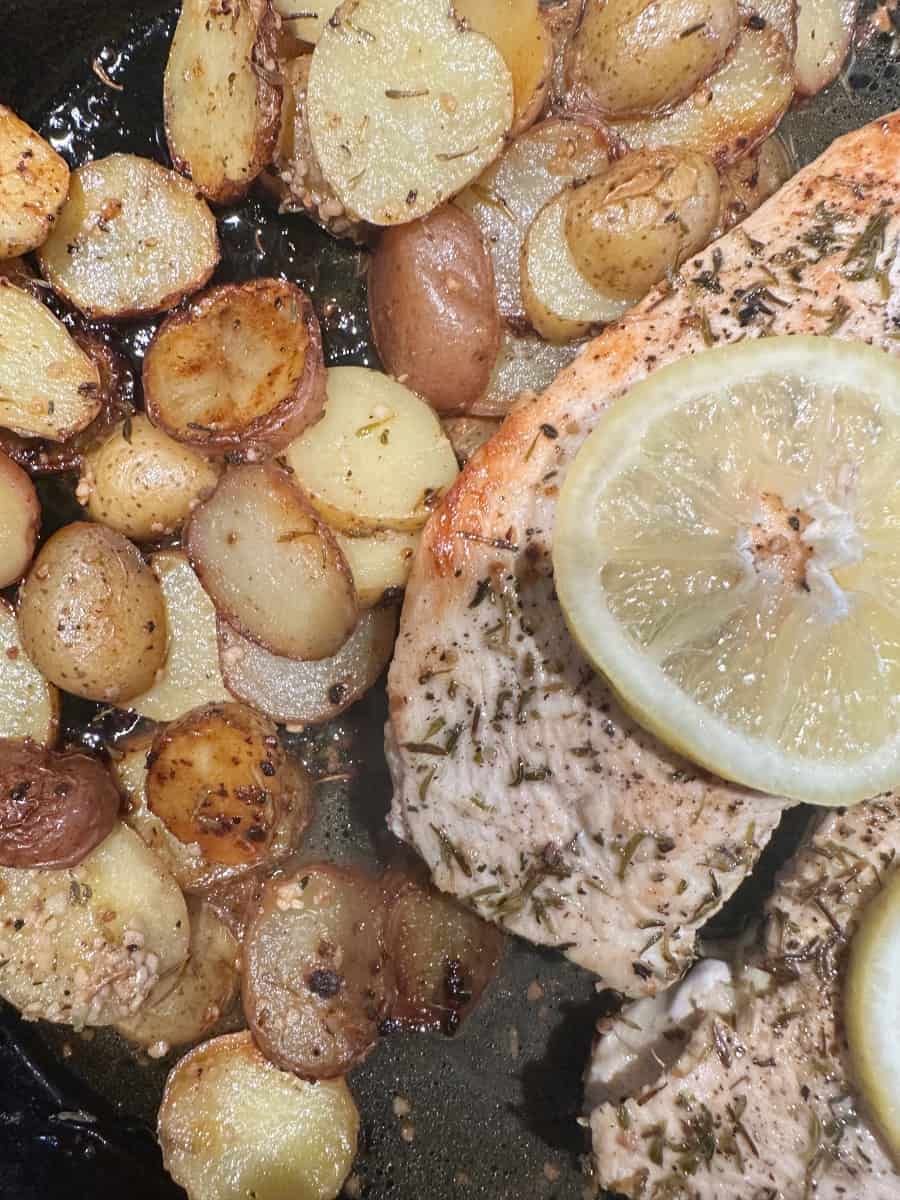 photo of the chicken and potatoes cooked in the cast iron pan