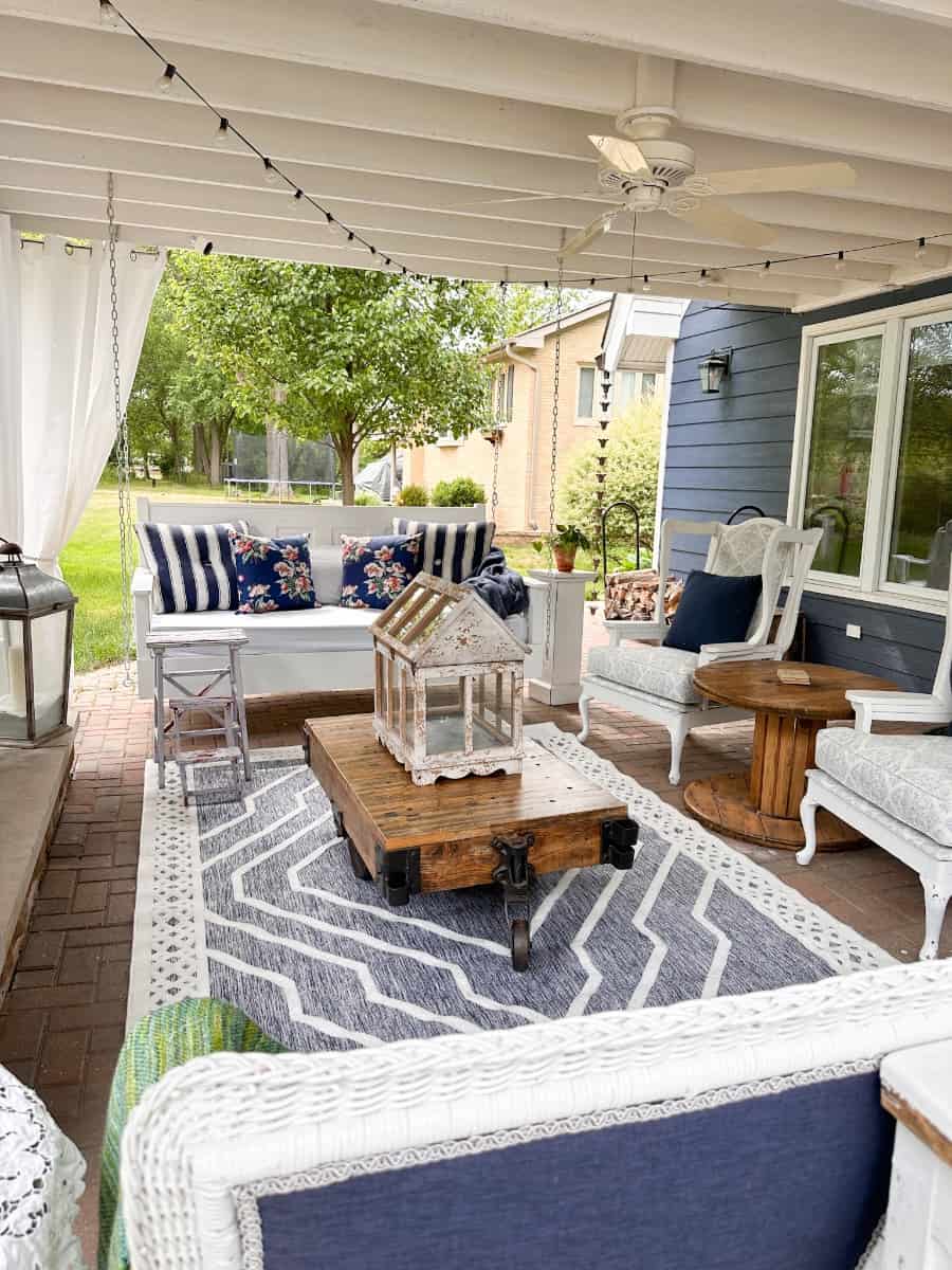 outdoor living room view of the bed swing and the deconstructed wing back stairs. You can also see the outdoor rug from boutique rugs