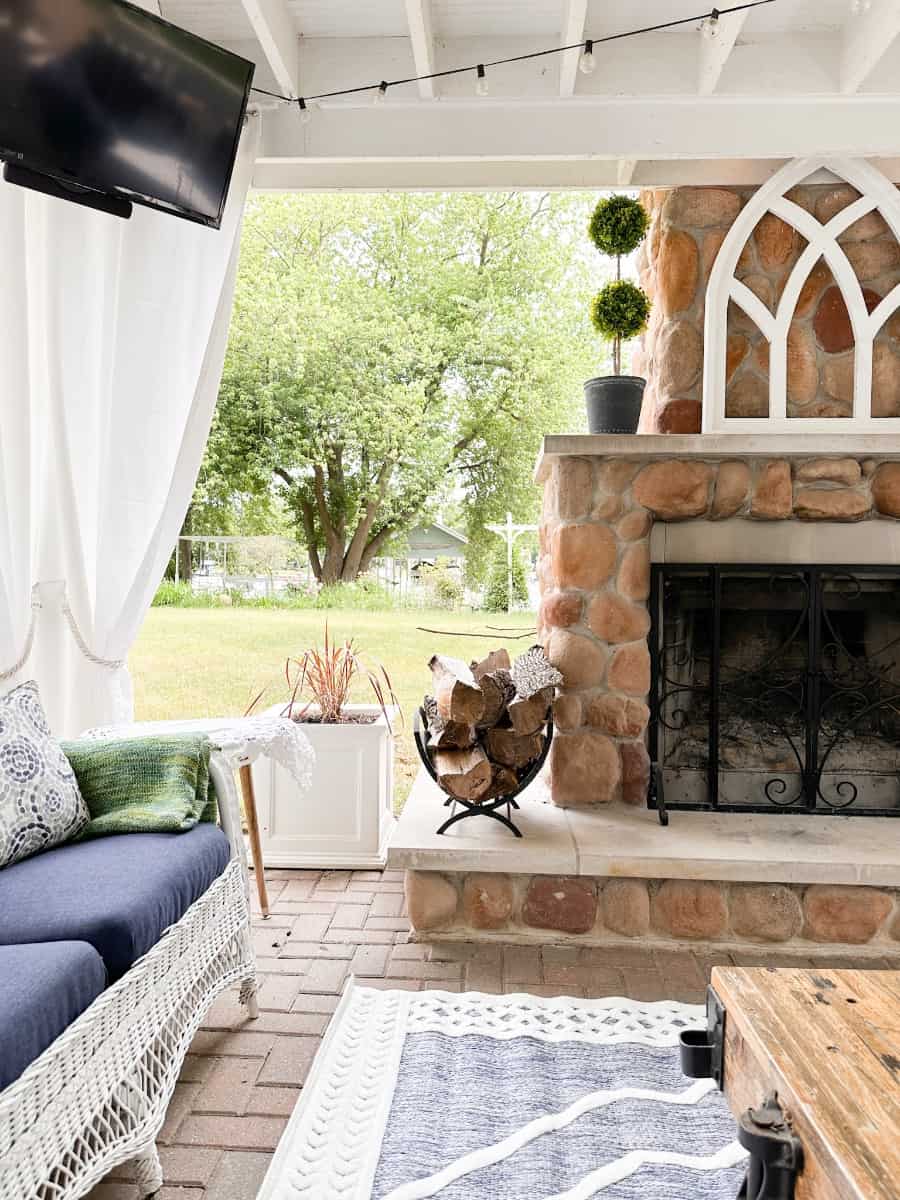 view of the river from our outdoor living room. You can also see a bit of the outdoor fireplace and the vintage wicker sofa