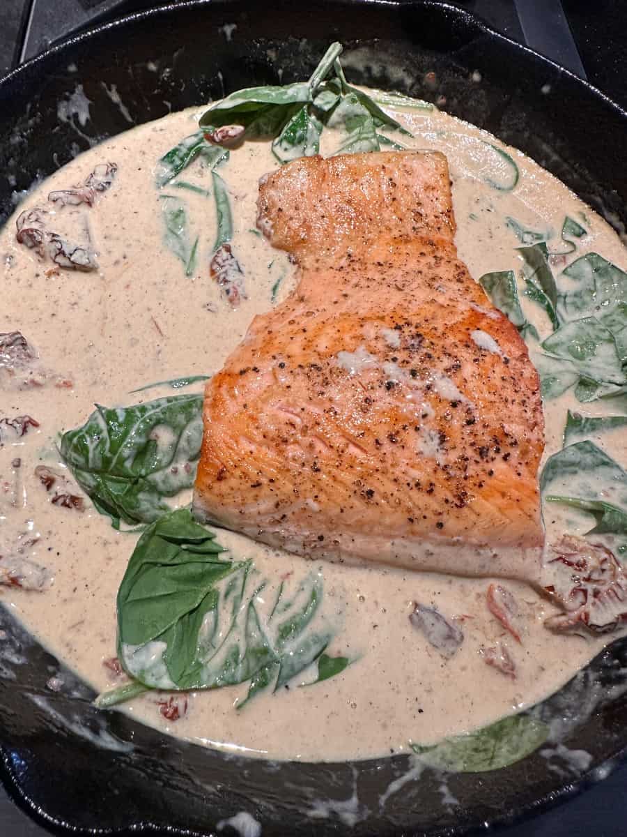 sun-dried tomato cream sauce with salmon in the cast iron skillet.