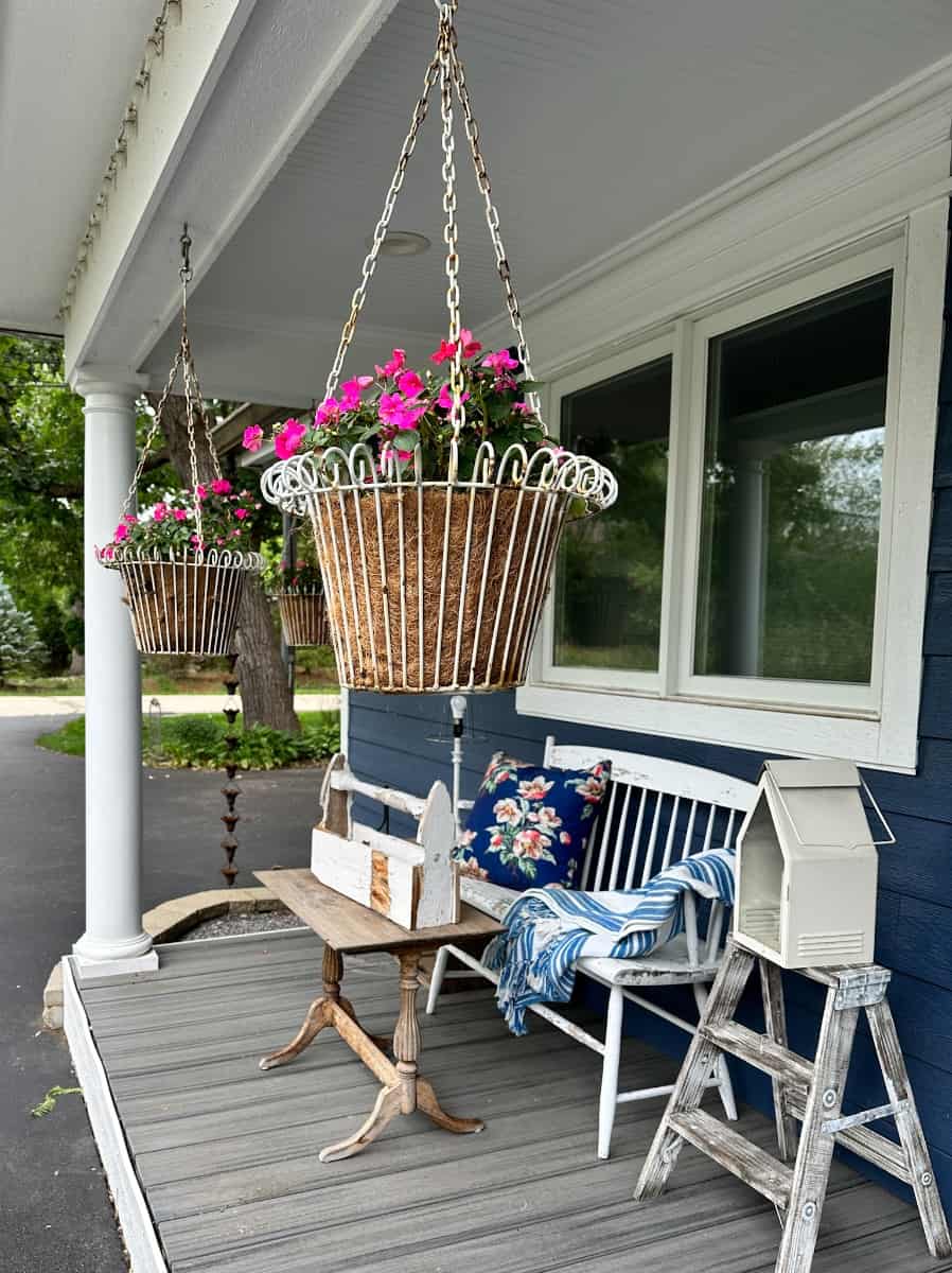 vintage hanging wire baskets with impatiens in them
