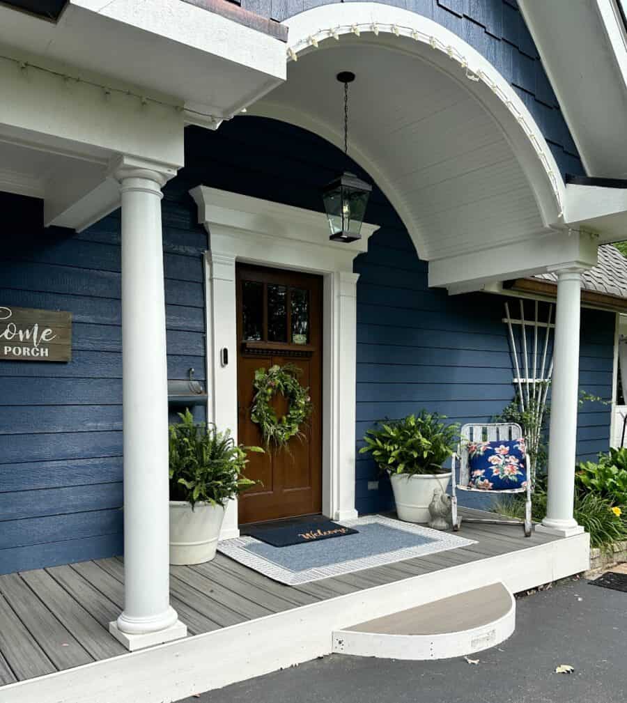 side view of the front door, new rug, and pots on my front porch