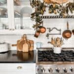 a photo of my stove and cabinet next to it in the kitchen. I have a fall garland hanging from the stove hood.