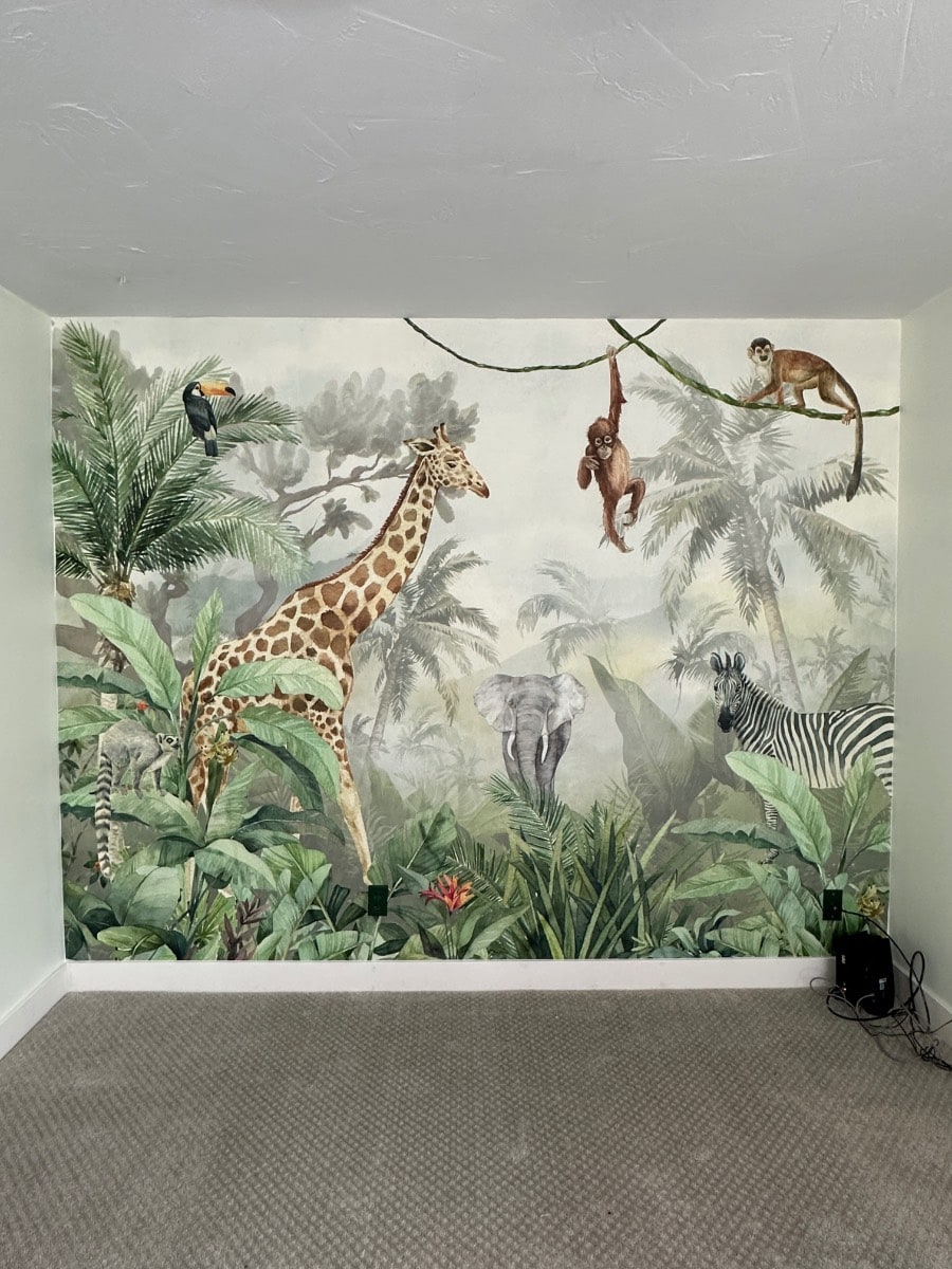 Baby Nellen Nursery with Jungle Theme Wallpaper Mural hung on accent wall.