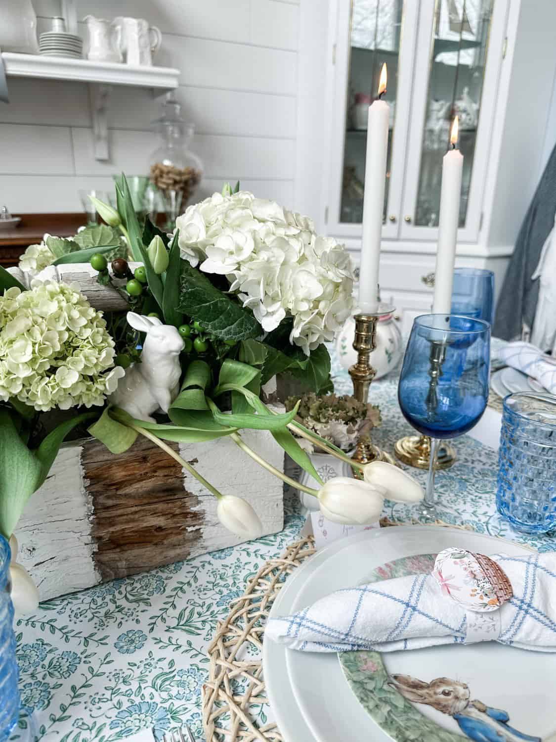 photo of the easter tablescape with the white vintage wood toolbox filled with tulips, and hydranges