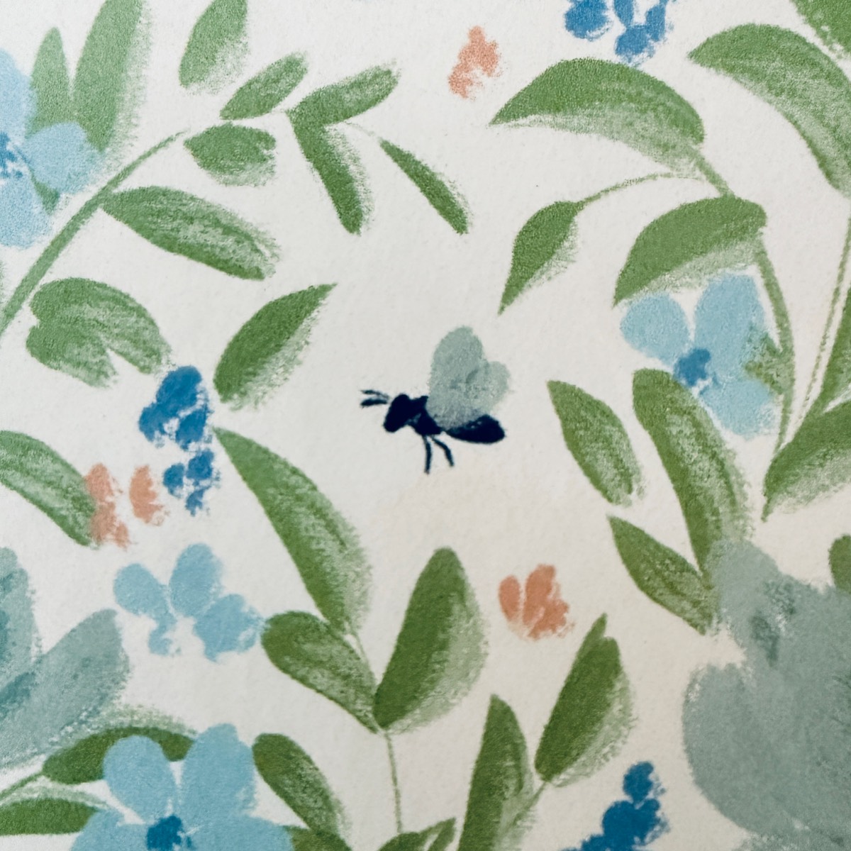 A watercolor illustration of a black bee surrounded by green leaves and blue and peach flowers on a white background—perfect inspiration for how to define an entryway with wallpaper.