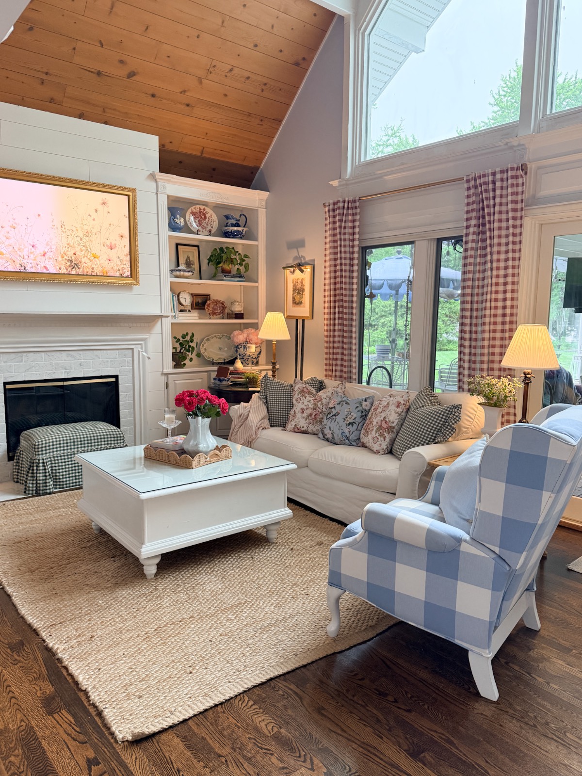 Bright living room with large windows—perfect inspiration on how to refresh your home for summer with cozy, airy style.