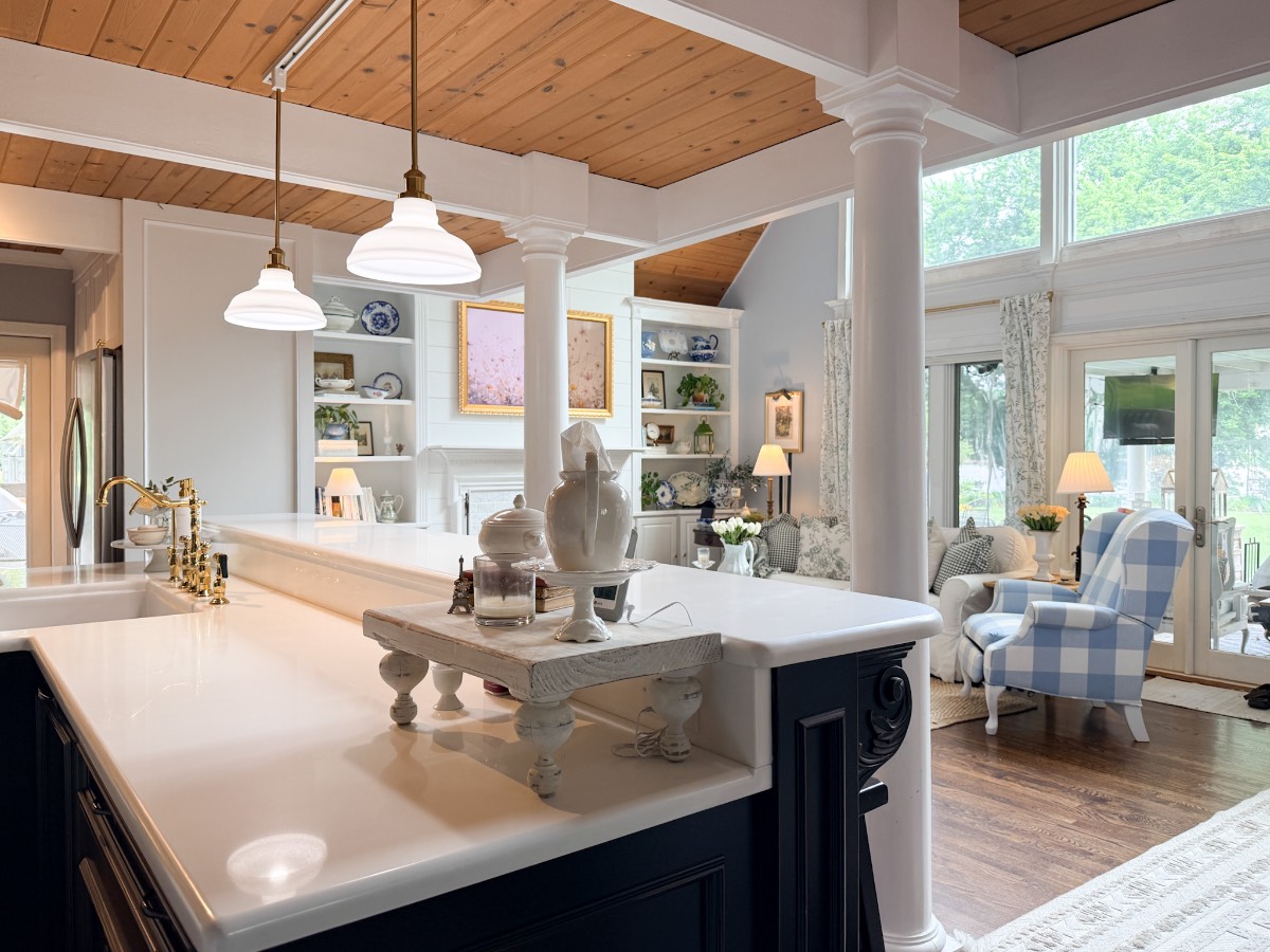 Bright, elegant kitchen and living area with white counters—see how to decorate a small home beautifully with cozy seating.