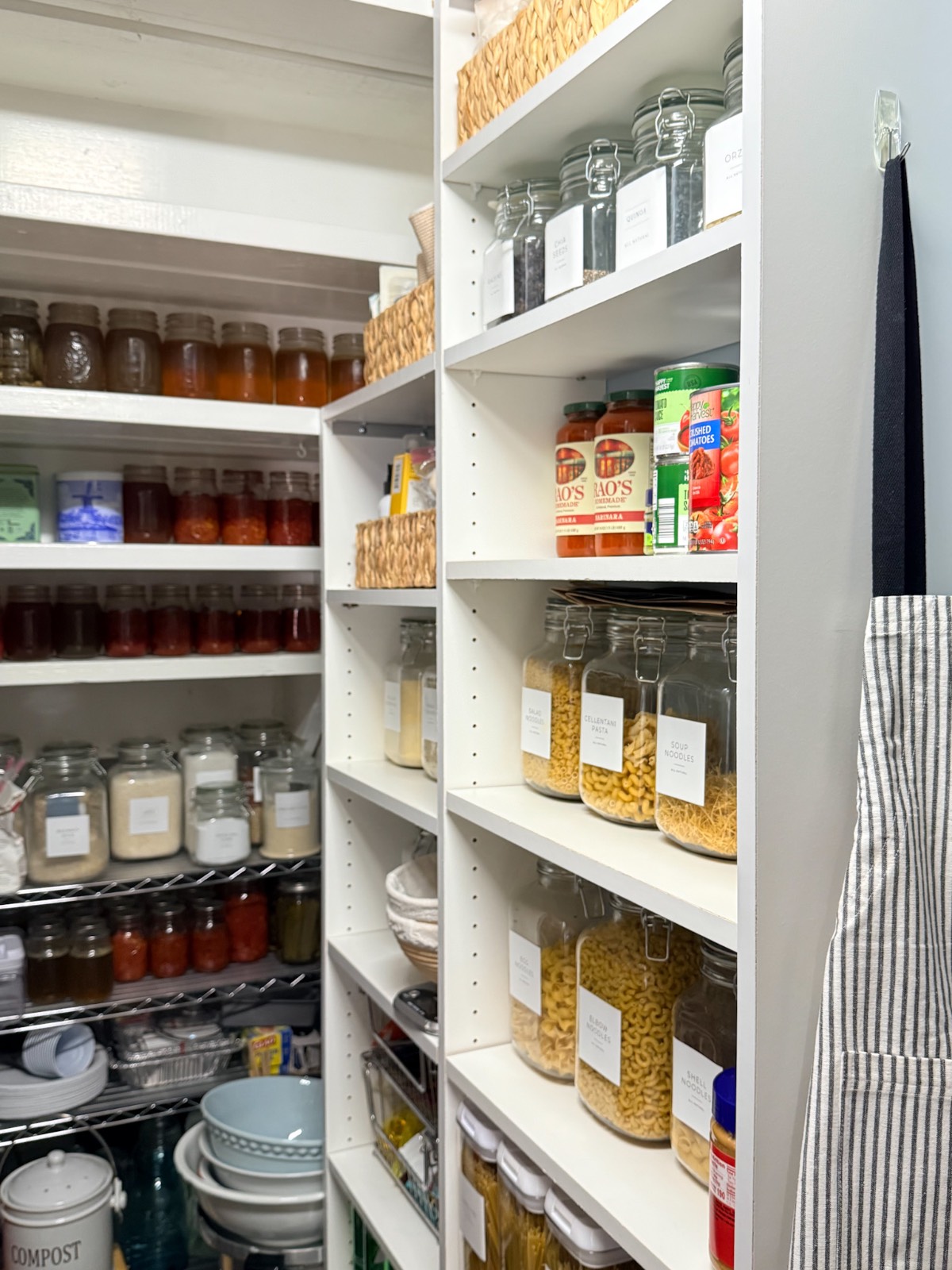 Organized pantry shelves with labeled jars, canned goods, and baskets—like a well-kept hall linen closet for dry foods.