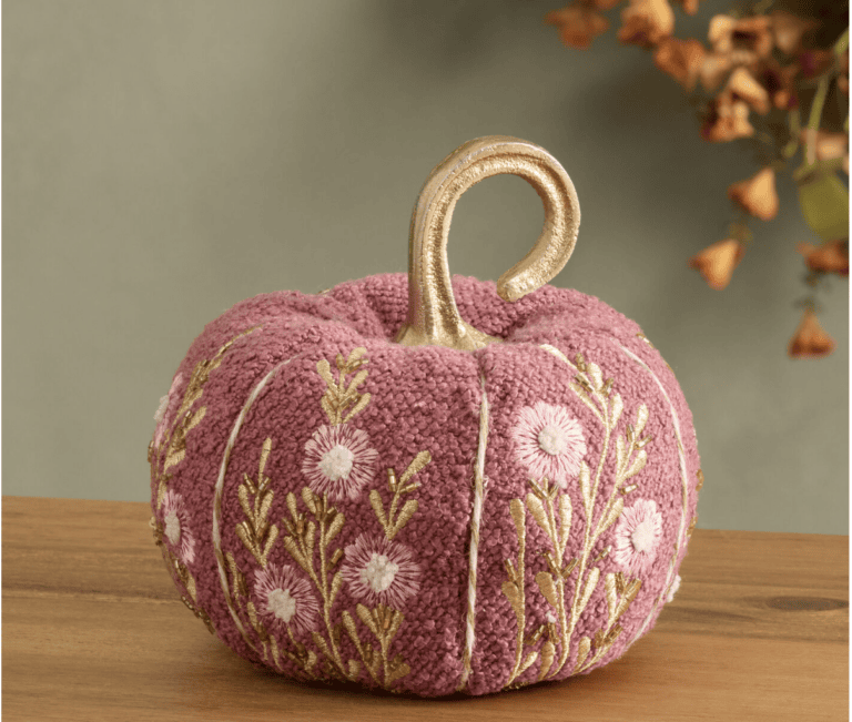 A pink textured pumpkin with embroidered flowers and a gold stem awaits your next Shopping with Friends adventure.