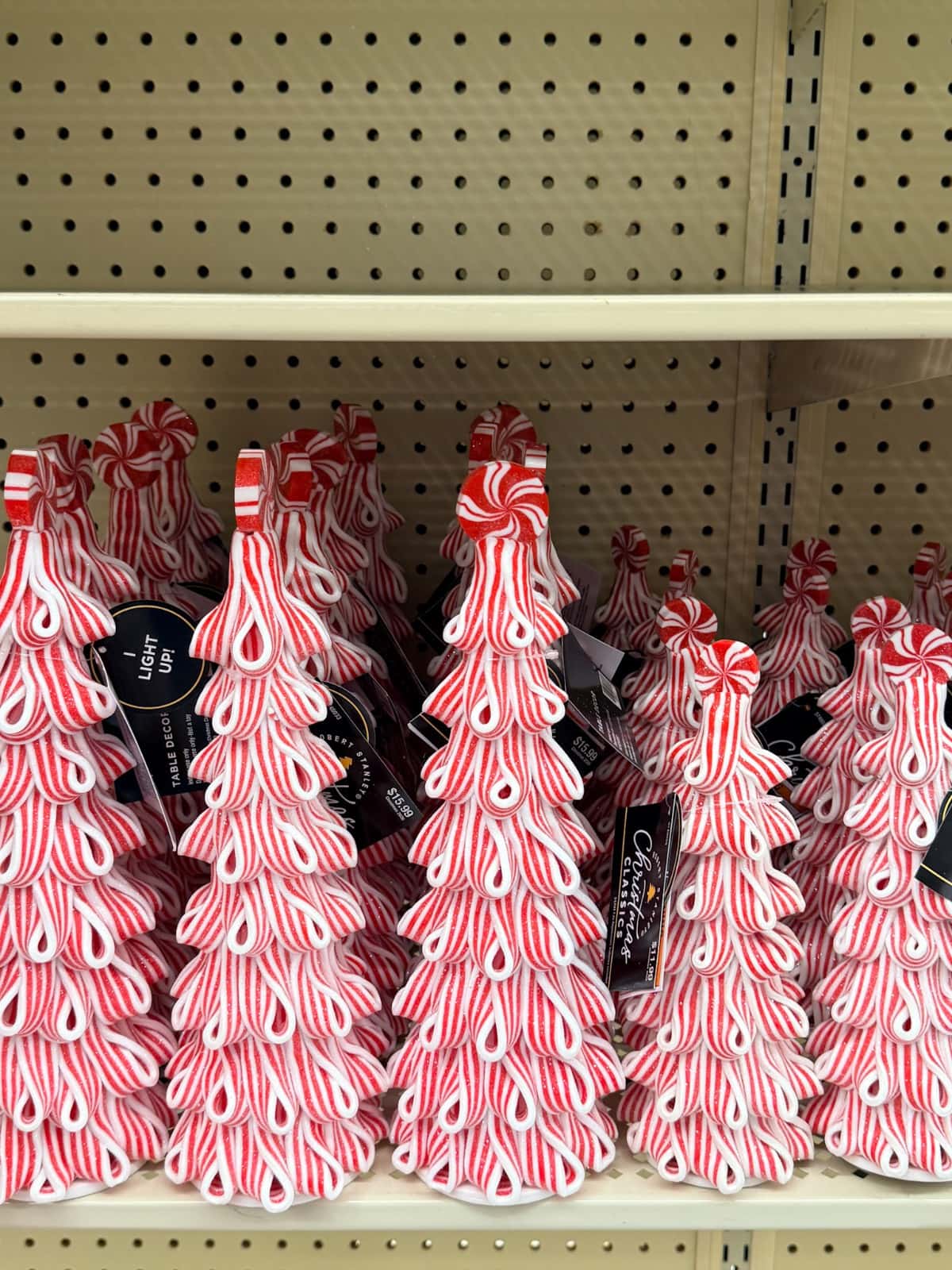 Red and white striped decorations line the shelf, perfect for holiday season planning or early Christmas in July prep.